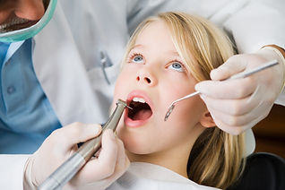 Young girl in a dentist's chair getting a check-up