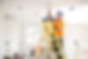 A professional installing lighting in a commercial space