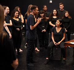 Stage Actors standing together talking about their live performance.