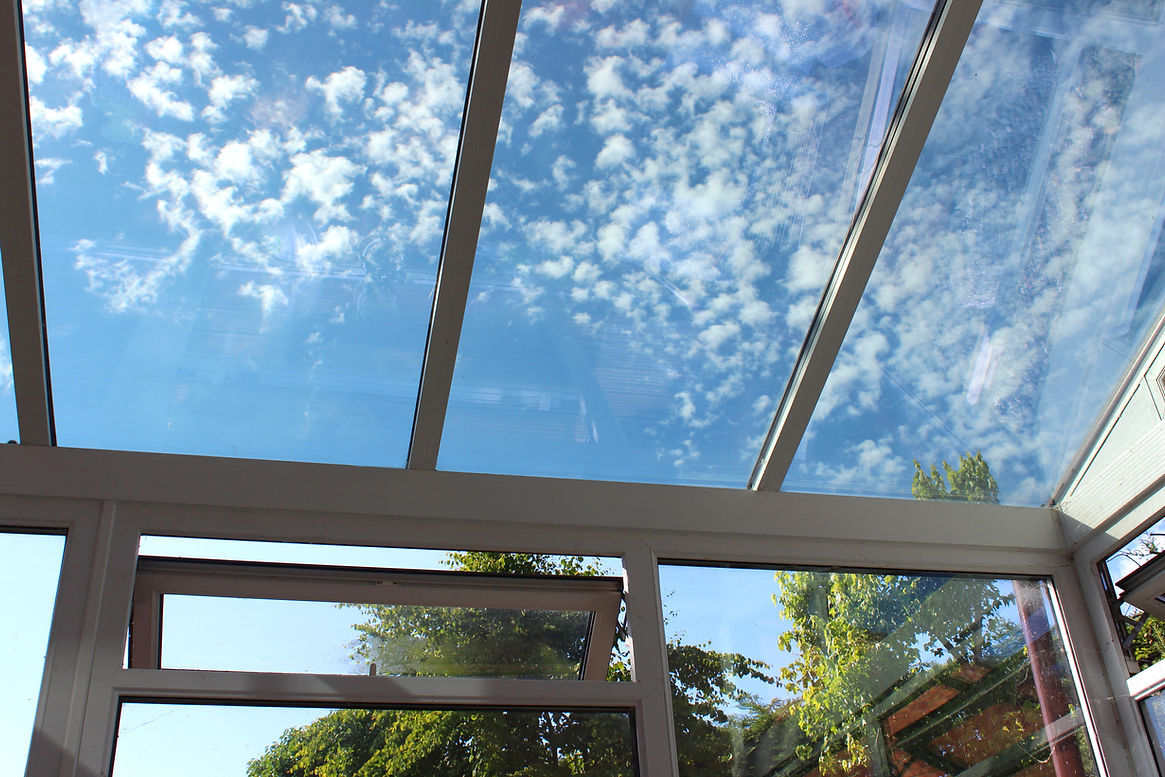 Photo showing a glass conservatory roof with panels of self-cleaning glass. This glass is
