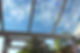 View of a blue sky through a glass conservatory roof