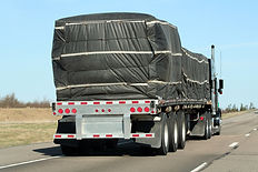 rear view of a flatbed trailer truck on highway