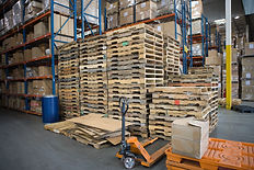 Wooden pallets stacked on top of each other in a warehouse