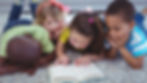 Group of children reading a book