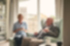 a nurse and an elder man smiling