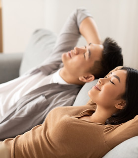 Couple Relaxing On Sofa