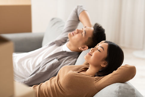Couple Relaxing On Sofa