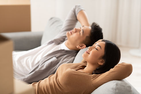 Couple Relaxing On Sofa
