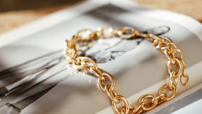 Gold bracelet resting on book