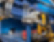 Close-up of a hydraulic control valve bank with four levers on blue industrial machinery