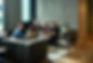 people sit on couches talking to one another