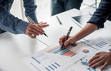 Two people working with data sheets