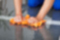 A man cleaning the dust on the floor with a duster