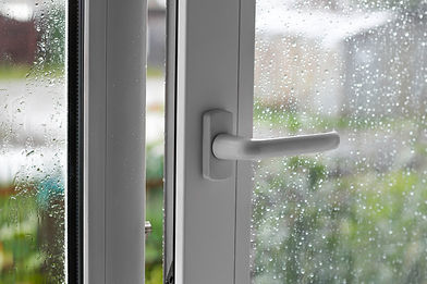 Open white plastic window. In the rainy weather. Closeup