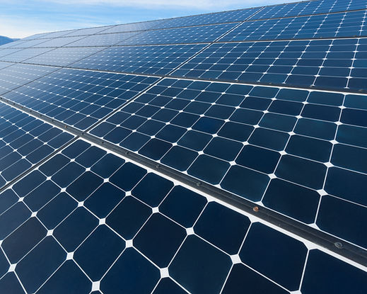 Close-up angled view of a modern blue photovoltaic solar panel array capturing natural light