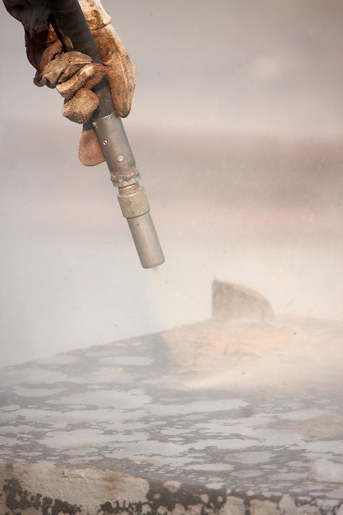 Sandblasting of metal structures at construction site