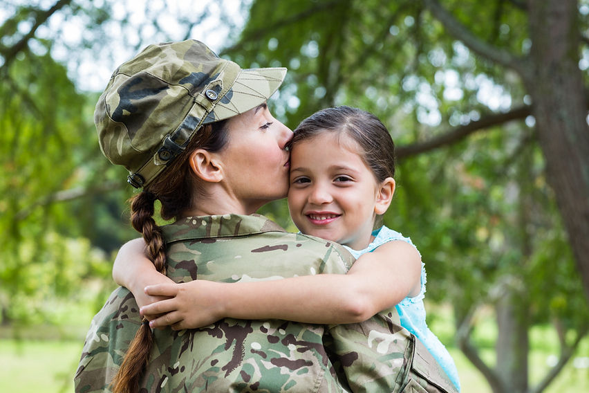 Woman veteran hugging her daughter