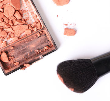 Crumbled blush compact with makeup brush