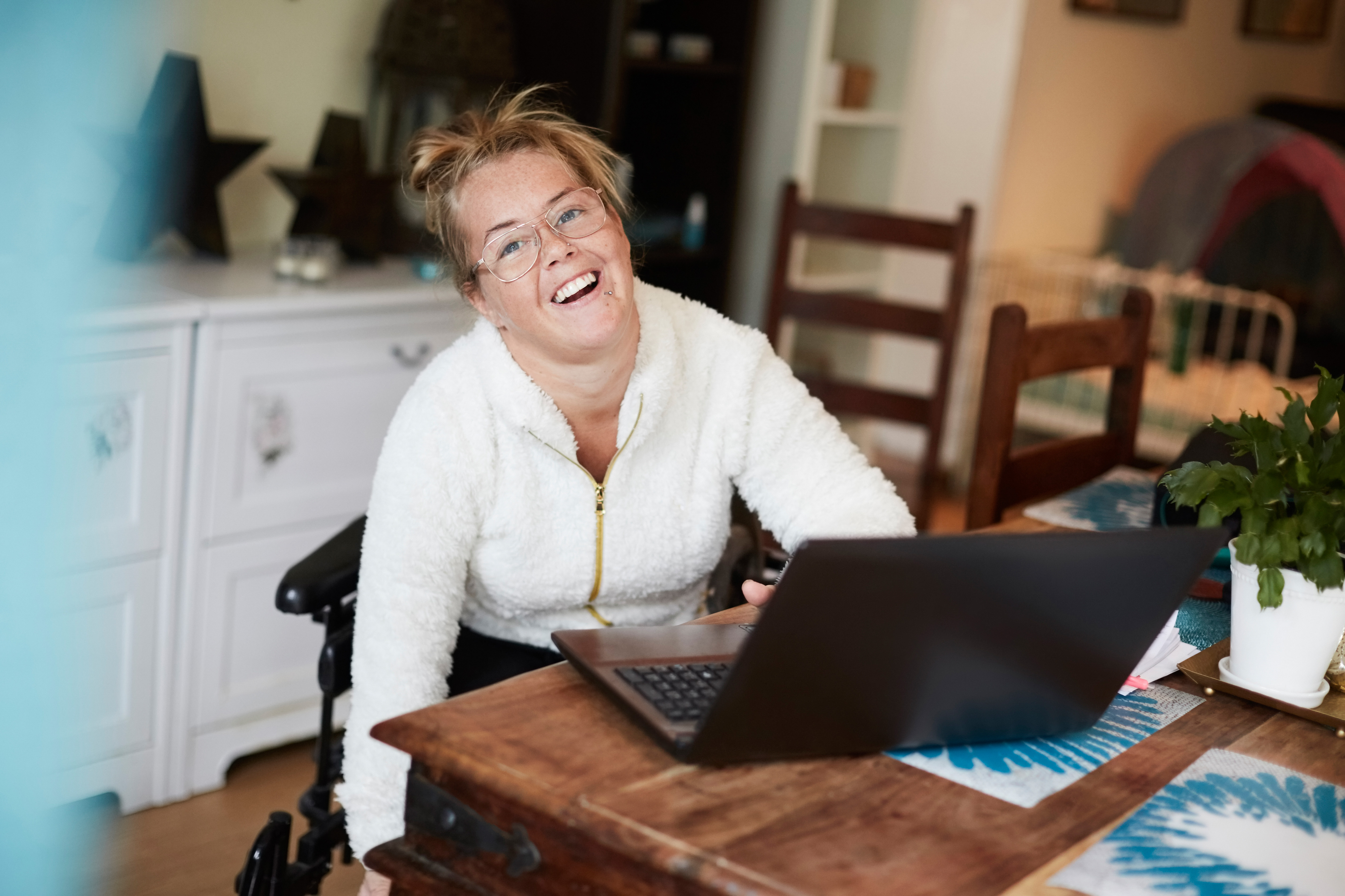 A person working on a laptop in a home office