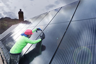 worker installing solar panel