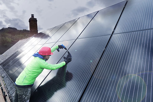 Man installing solar panels on roof