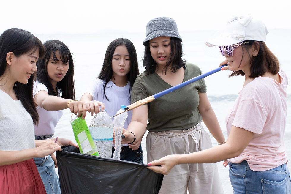 Women putting trash in a trash bag