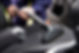A person using a brush to clean a car seat, focusing on removing dirt and stains from the fabric