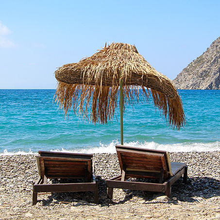 sunning chairs on beach by ocean