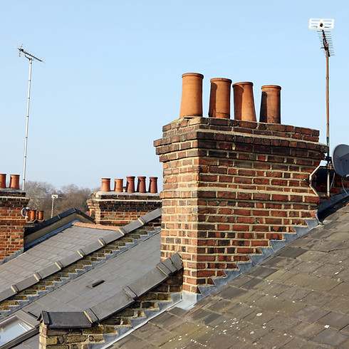 Residential rooftops with chimneys and TV aerials