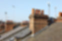 Residential rooftops with chimneys