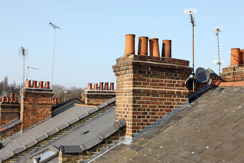 Residential rooftops with chimneys and TV aerials