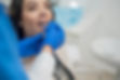 Dentist inserting dental retainers