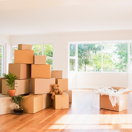 Boxes stacked in living room of new house