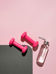 Pink dumbbells and water
