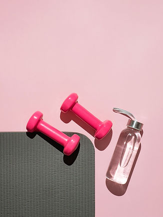 Pink dumbbells and water