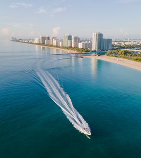 A boat on beautiful blue gulf water near the shore