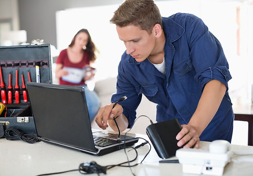 Technician servicing electronic device with tools on desk