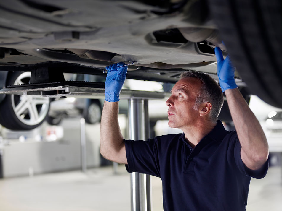 Mechanic working underneath car