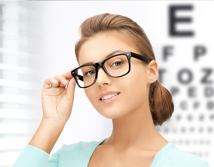 woman in eyeglasses with eye chart in the background
