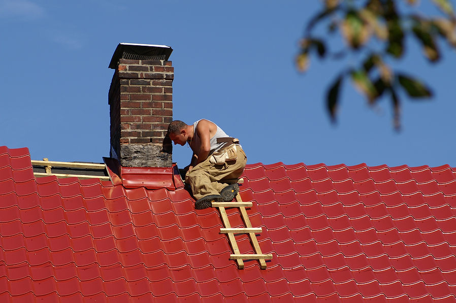 man working on the top of the roof