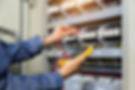 Electrician engineer work tester measuring voltage and current of power electric line in