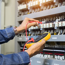 Electrician engineer work tester measuring voltage and current of power electric line in