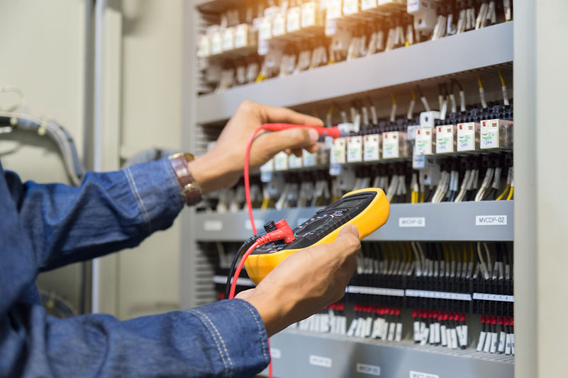 A technician is using a modern multimeter to test the Voltage