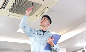 Service Tech Examining Air Conditioner