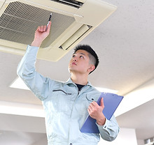 Engineer Examining Air Conditioner