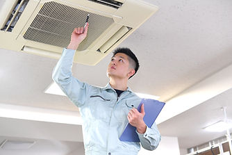 Zwecks Technician Examining Air Conditioner