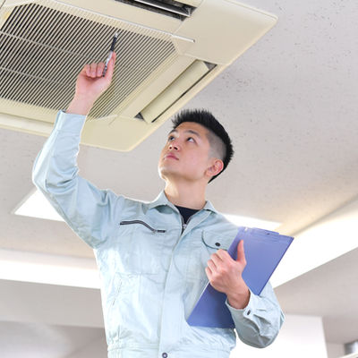 Engineer Examining Air Conditioner