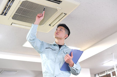 Engineer Examining Air Conditioner