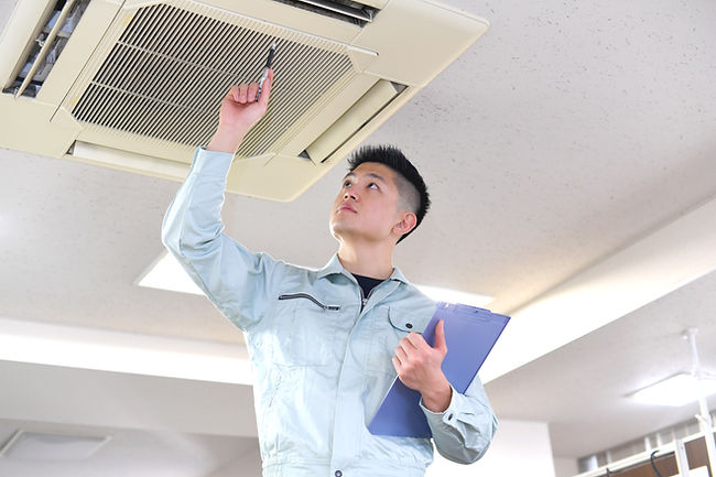 Engineer Examining Air Conditioner