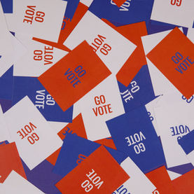 Random assortment of red, white, and blue cards that all say "Go Vote."